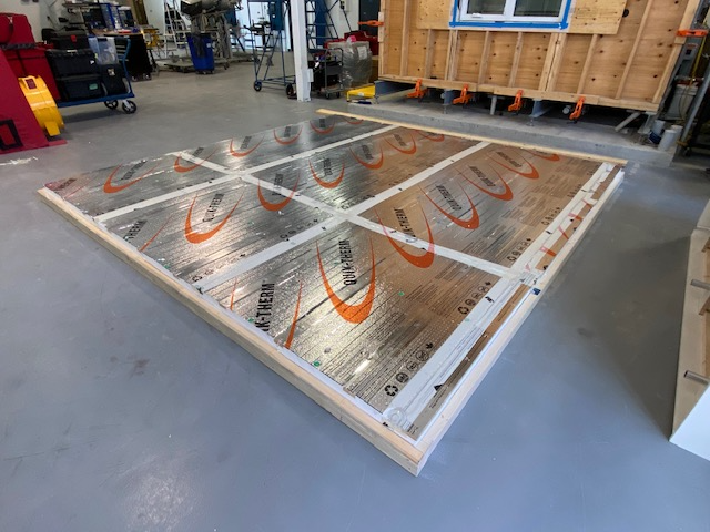 Person fastening insulation to framing