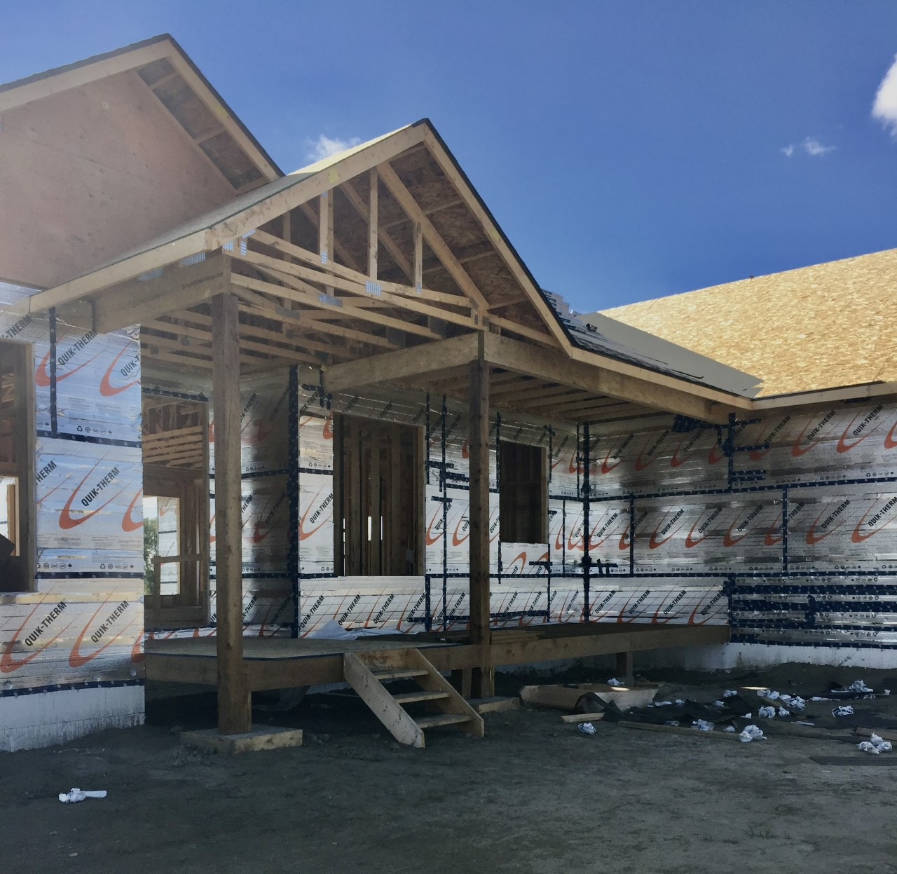 Person fastening insulation to framing