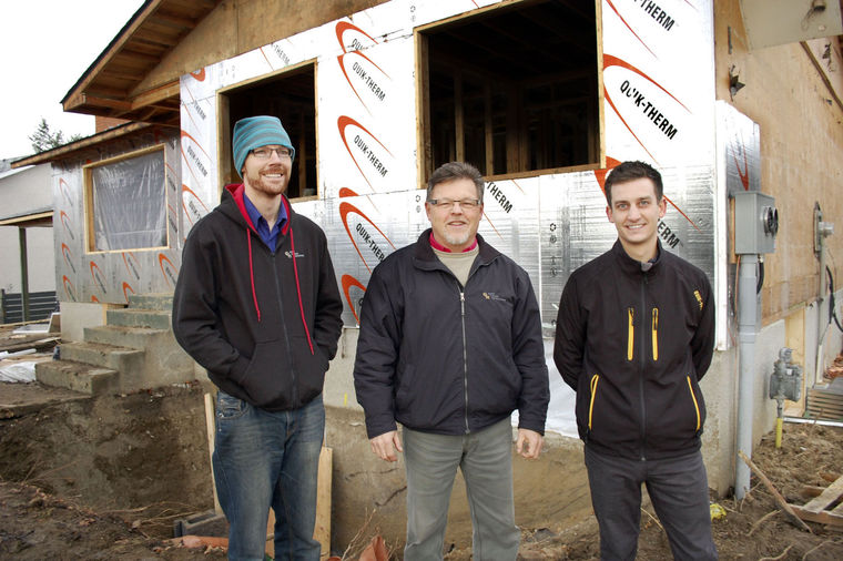 Kyle Turner, left, and his dad Gord Turner of Gord Turner Revnovations with Derek Snitynsky of Quik-Therm Insulation at the Kelowna house that’s been completely gutted and is being rebuilt, including new Quik-Therm Insulation on the exterior and basement walls.